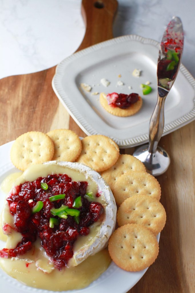 This delicious sweet and spicy brie recipe comes together without a whole lot of work involved. Just warm the brie and top with a simple 10 minute cranberry jalapeño sauce. It's so creamy and such an unusual combination, it will be gone in no time!
