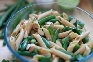 Citrusy, cilantro pasta salad with peas, green beans and almonds by Everybody Craves.